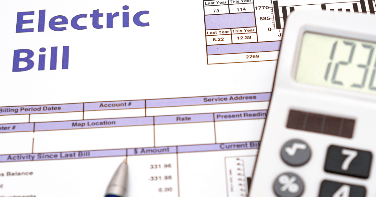 Electric bill document with highlighted title, calculator, and pen, illustrating energy costs related to HVAC usage and maintenance strategies.