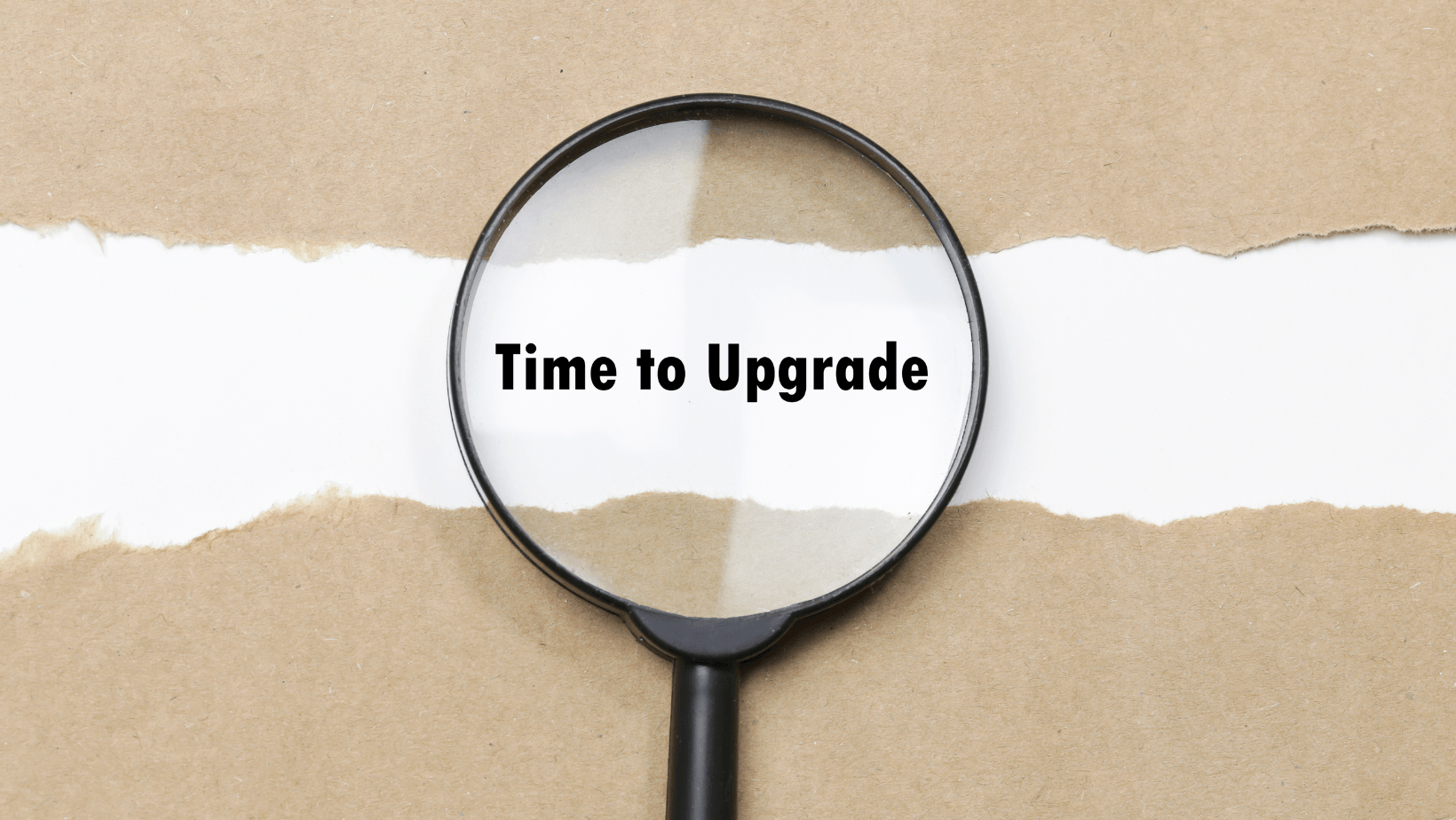 Magnifying glass highlighting the text "Time to Upgrade" on a torn paper background, symbolizing the need for HVAC system upgrades.