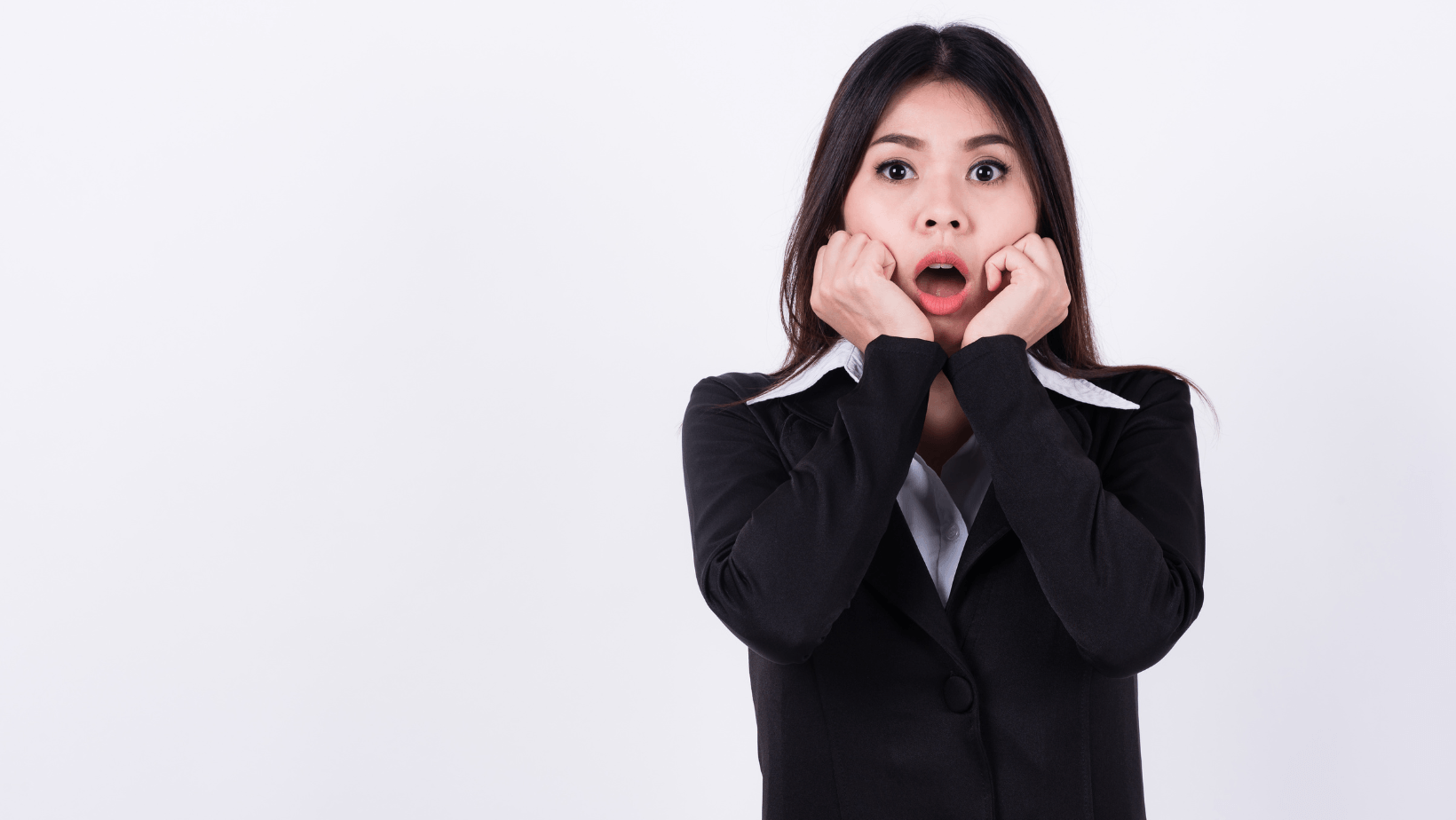 Woman in business attire with a shocked expression, illustrating common air conditioning issues and homeowner concerns.