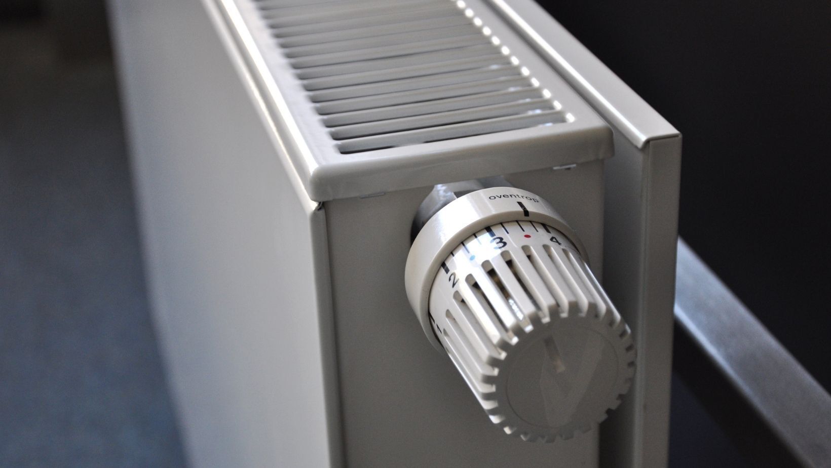 Heating radiator with adjustable thermostat dial, relevant to home heating tips and HVAC services.