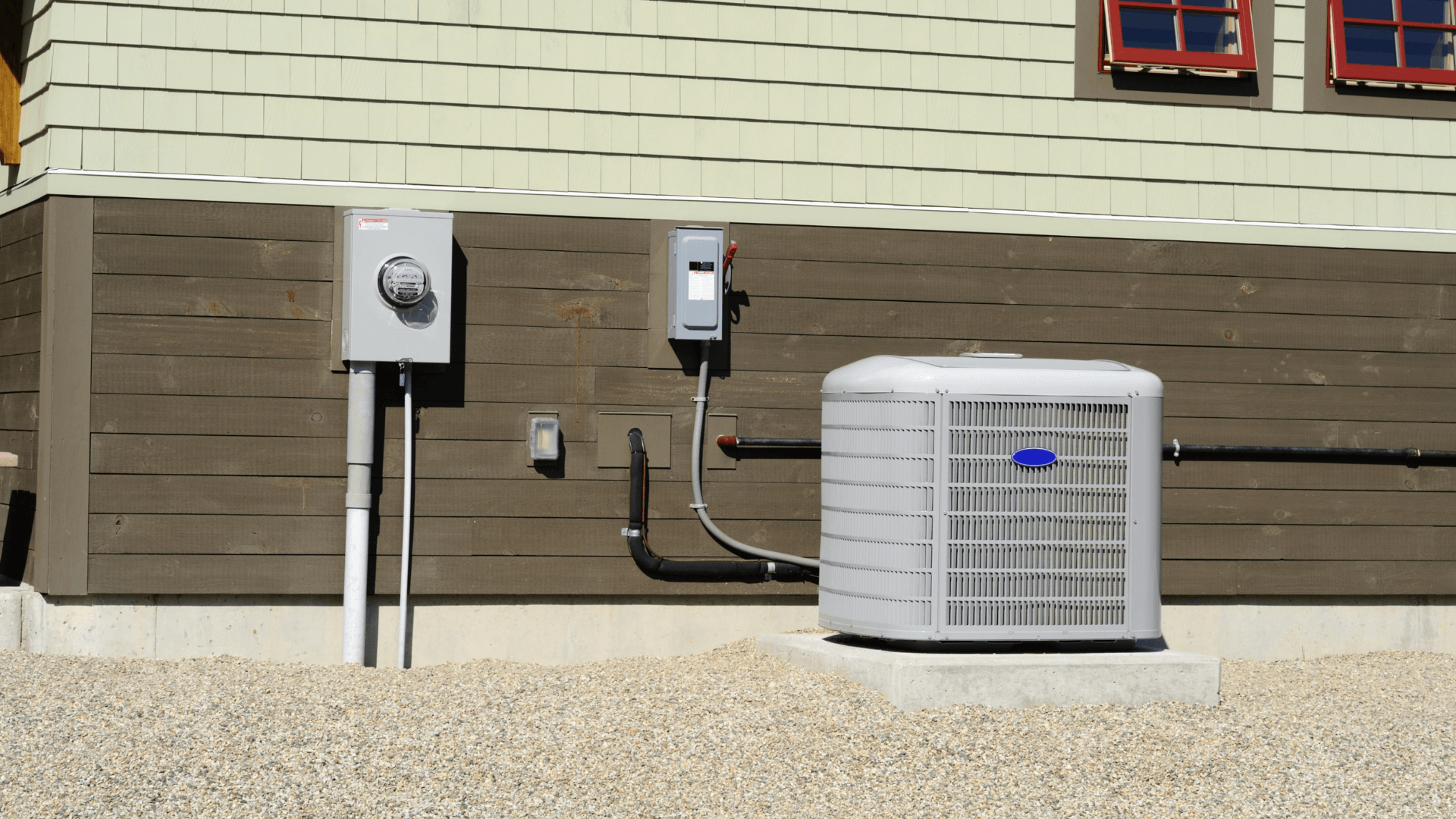 HVAC outdoor unit installed beside a home, with electrical meter and conduit, illustrating AC installation and maintenance services.