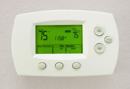 Programmable thermostat display showing indoor temperature at 75°F and heat setting at 75°F, illustrating energy efficiency and comfort for homeowners.