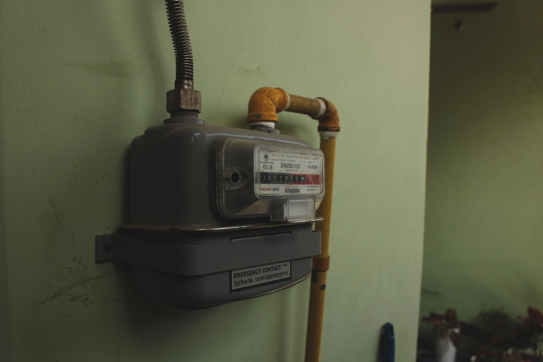 compact wall-mounted tankless water heater beside a traditional storage tank in a clean utility room compact wall-mounted tankless water heater beside a traditional storage tank in a clean utility room