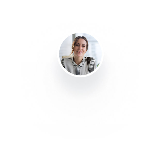 Smiling woman wearing a striped shirt sitting in a bright office.