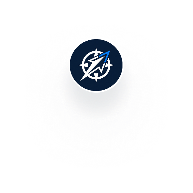 Portrait of a man with a trimmed beard and short hair wearing a buttoned gray shirt, in front of a white background with partial text and a brick wall.