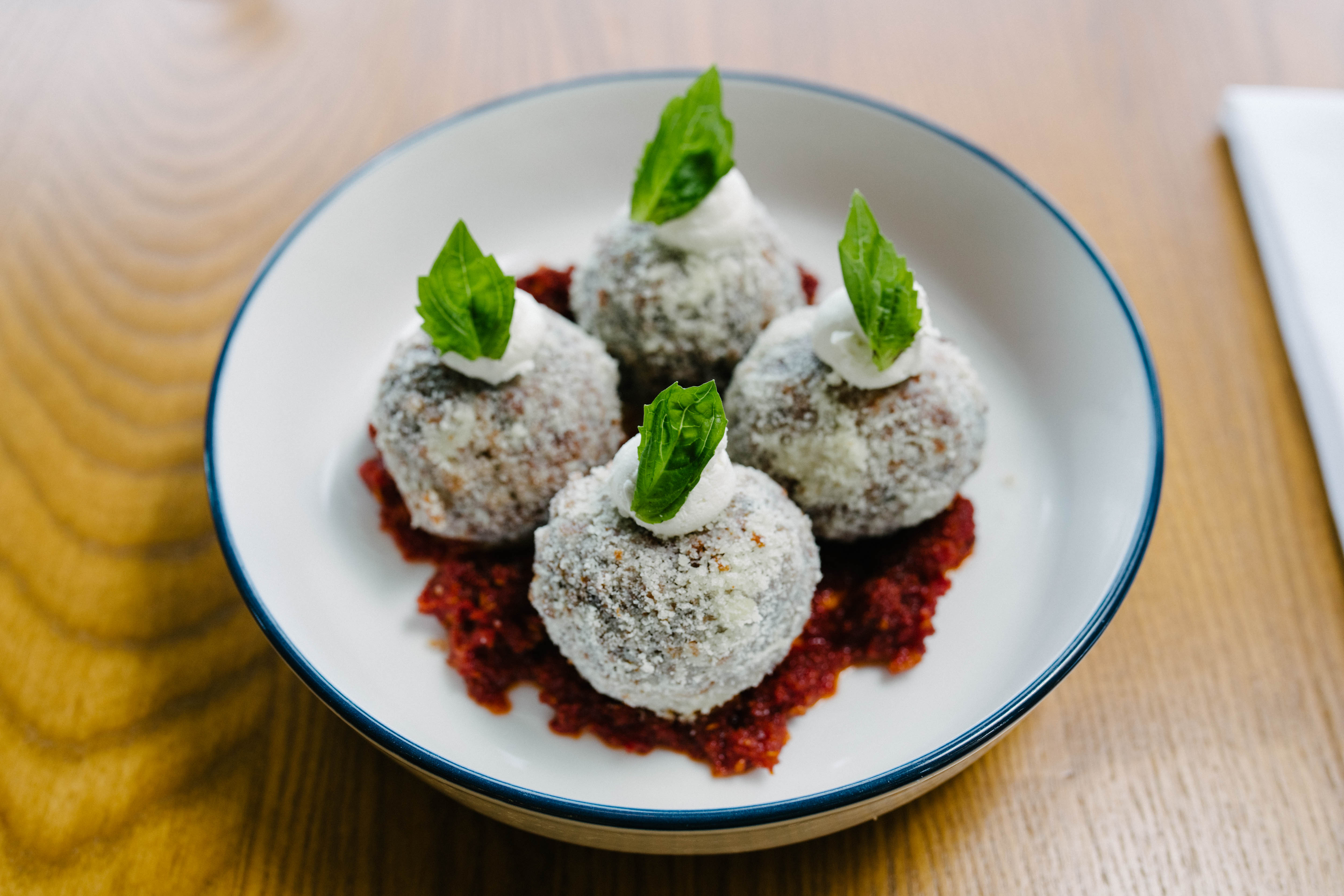 Ricotta fritters plated at Osteria Novella