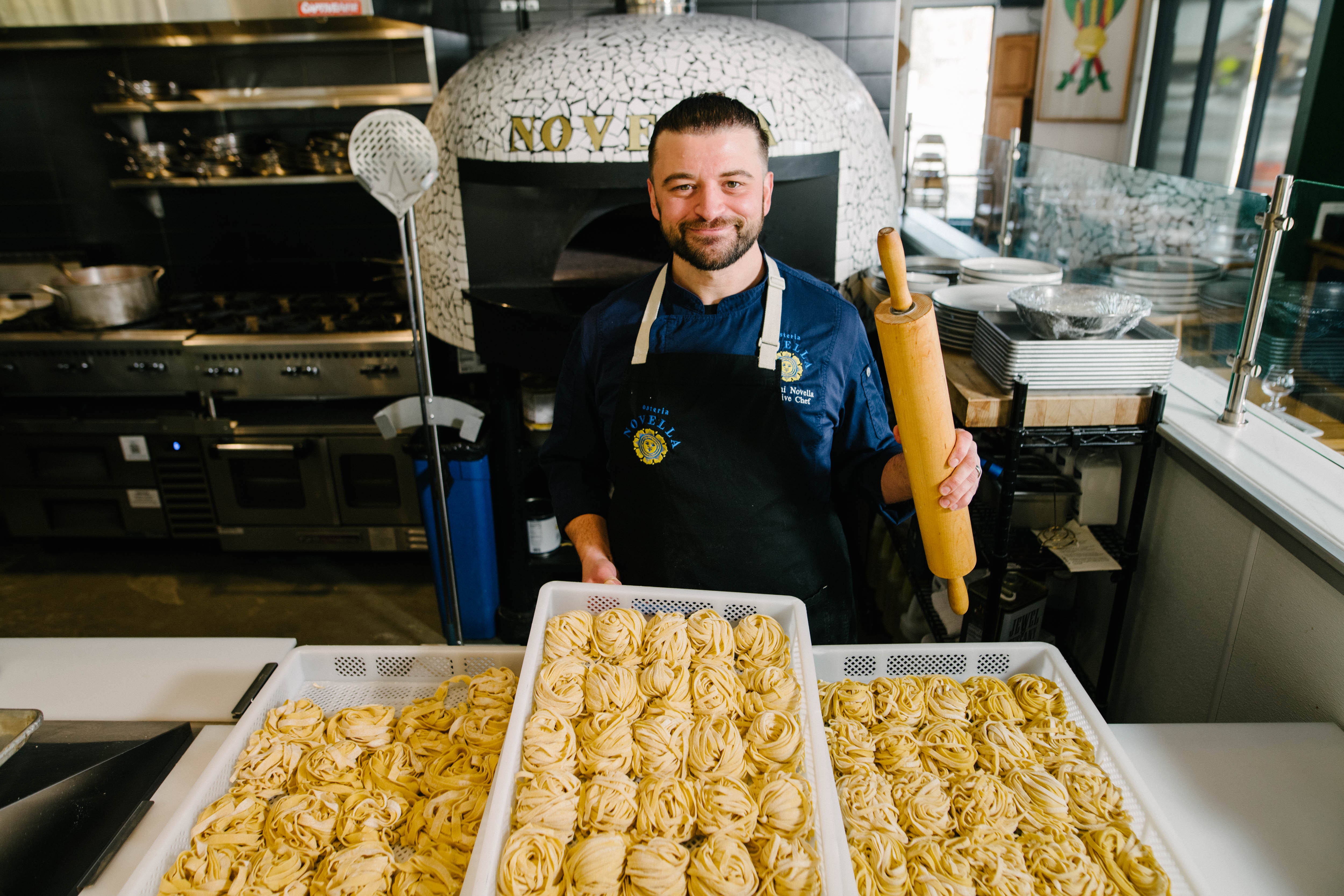 Chef Giovanni Novella with fresh pasta at the pizza oven