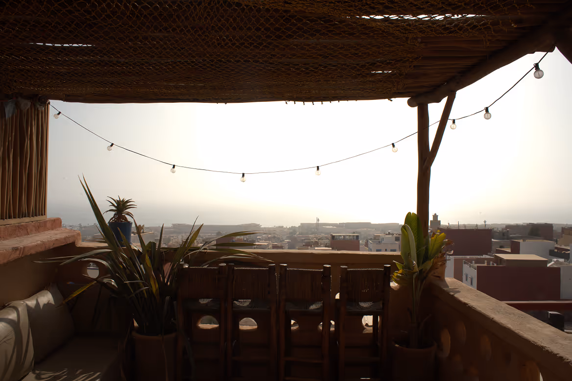 Shaded terrace lounge with ocean view at Salt House Morocco surfhouse