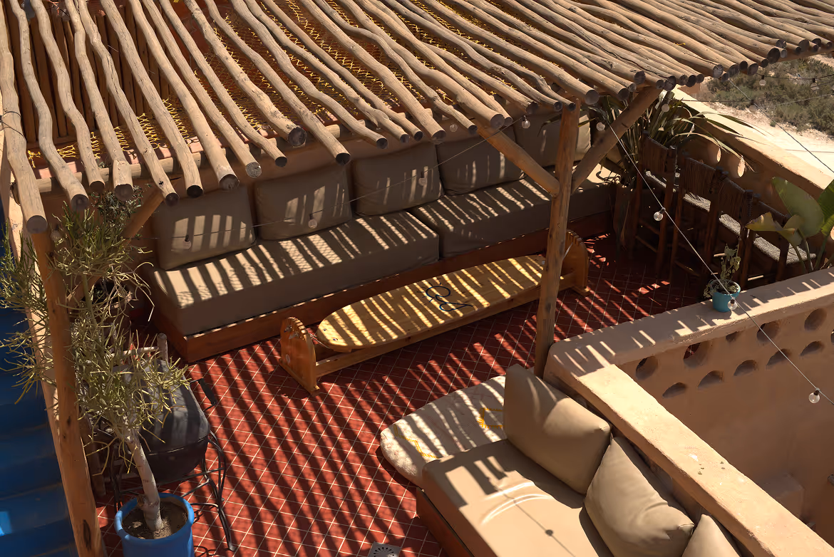 Shaded rooftop dining area with traditional Moroccan decor at Salt House Morocco