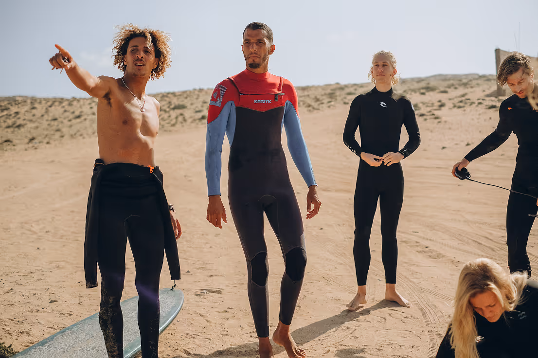 Surfers stretching before surf coaching session in Morocco