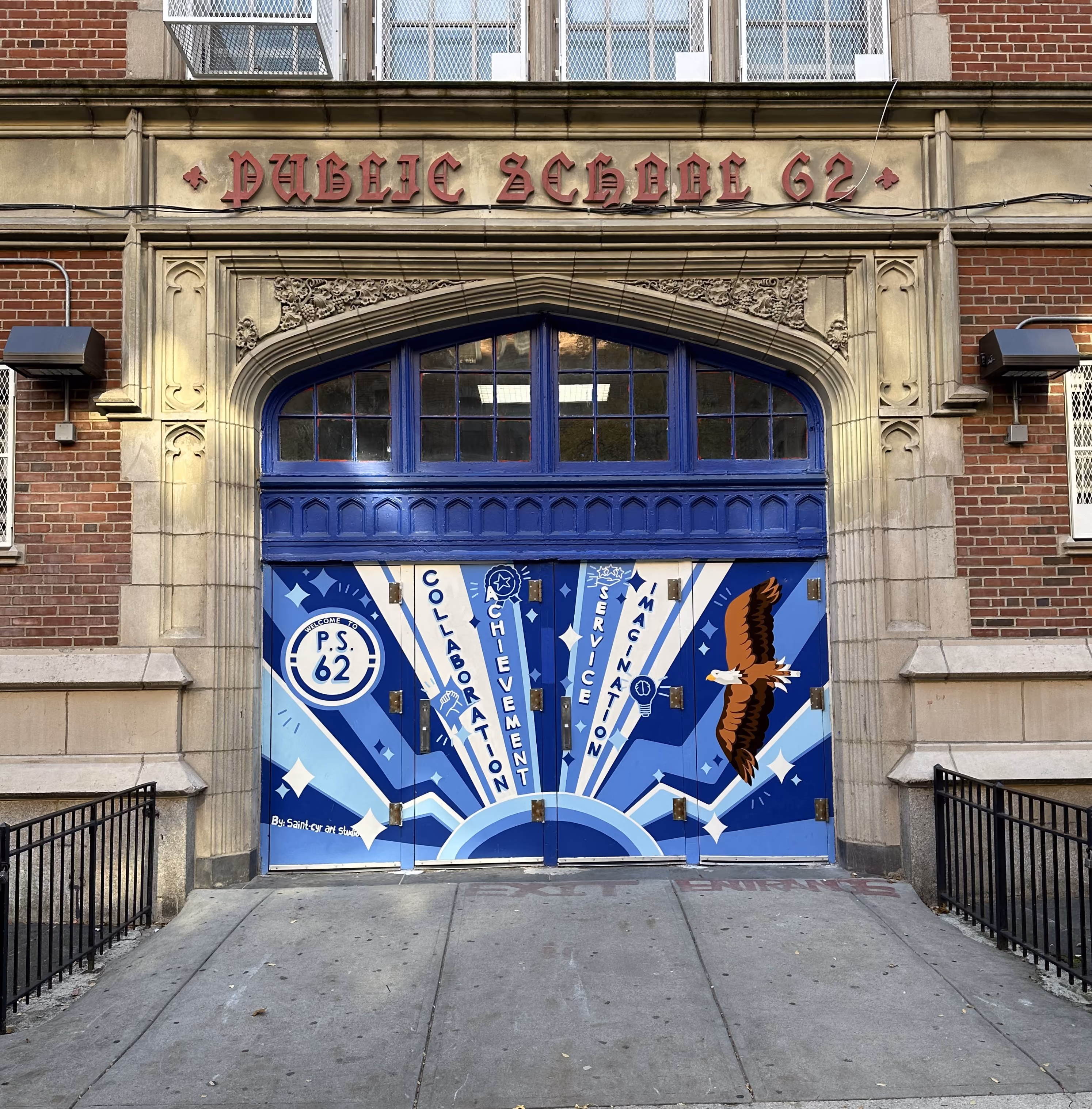 Public School 62 entrance doors with eagle mural and school values