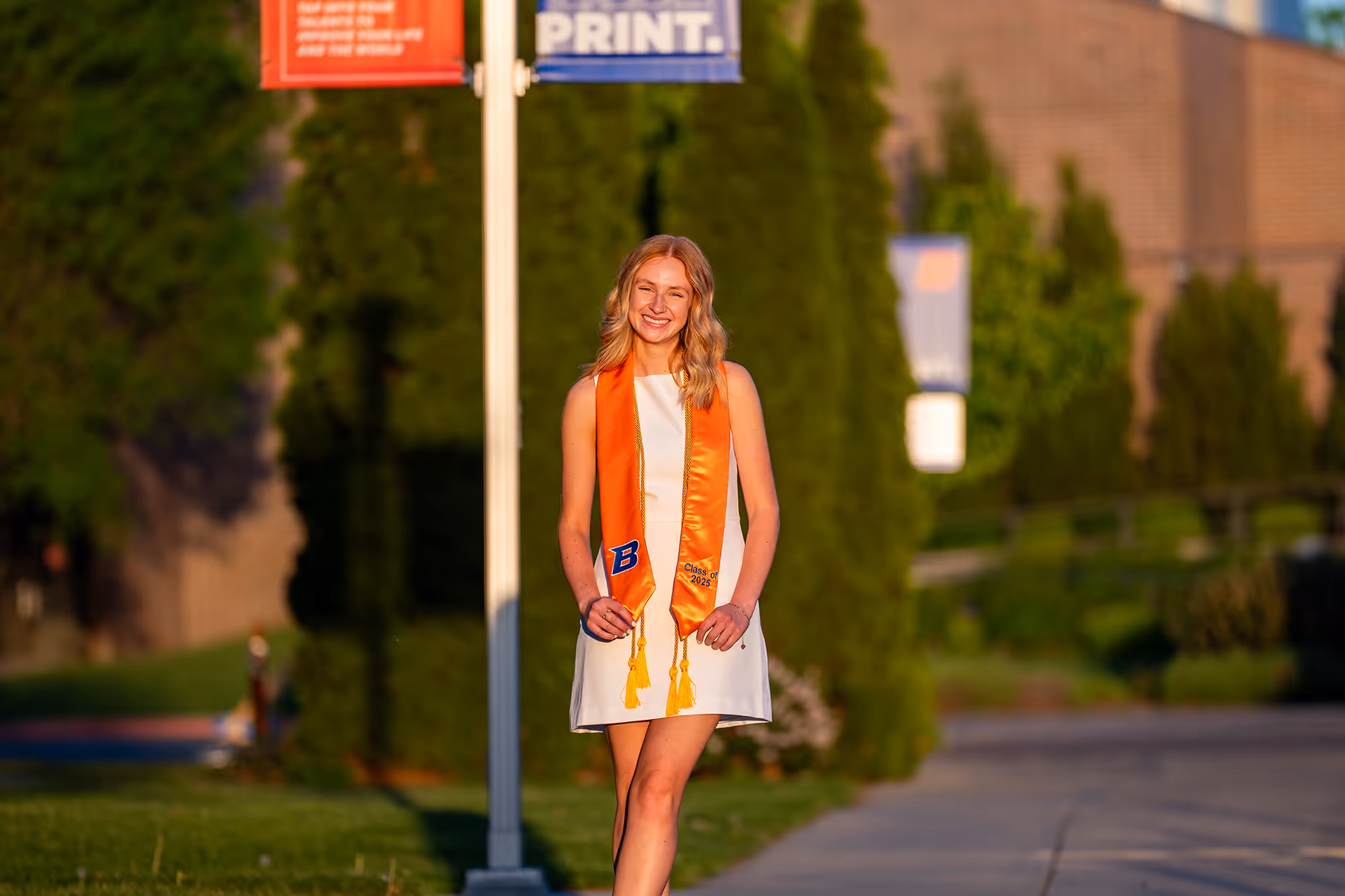 A Boise State Graduate smiling in her graduation attire.