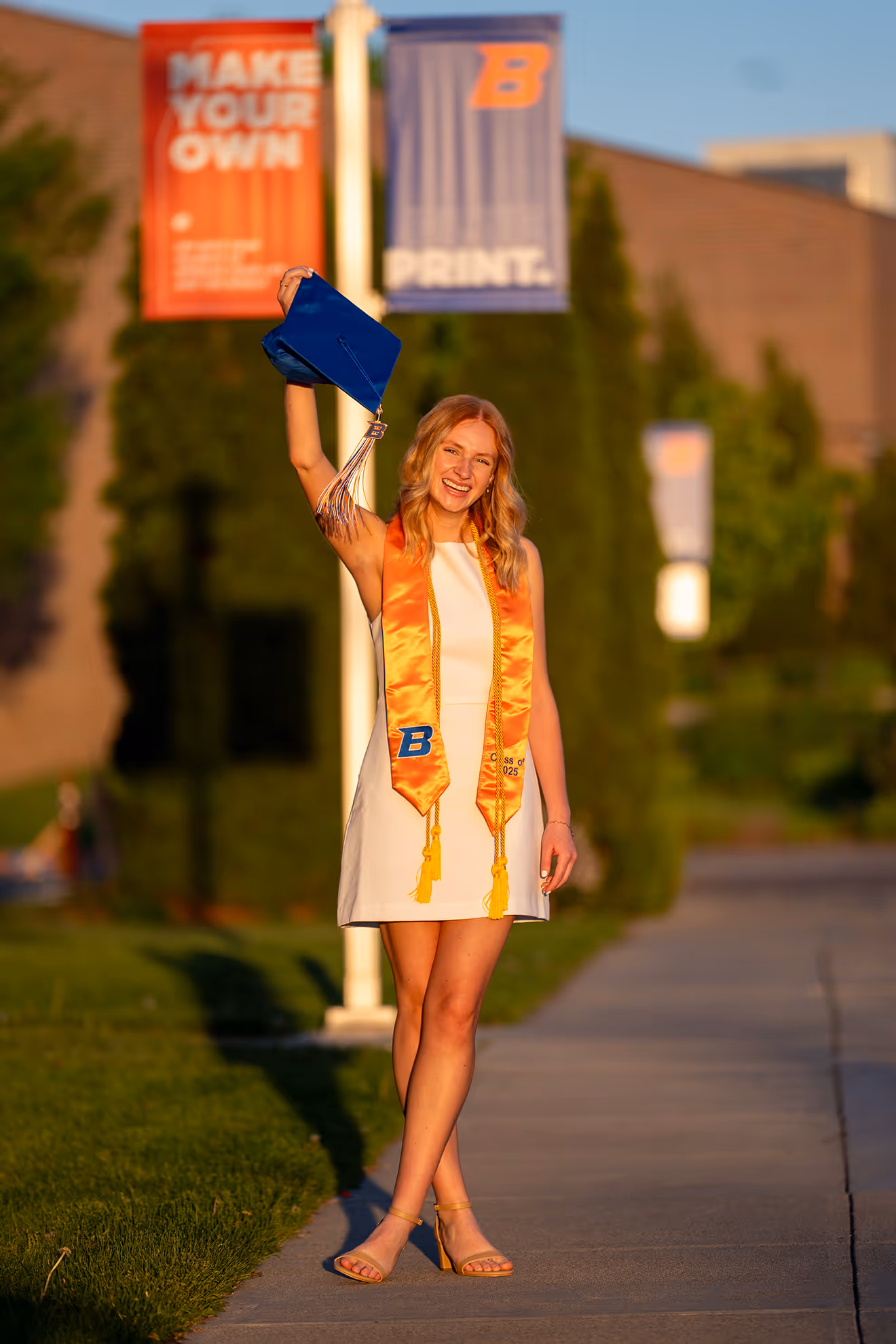 A Boise State graduate holding up her graduation cap.