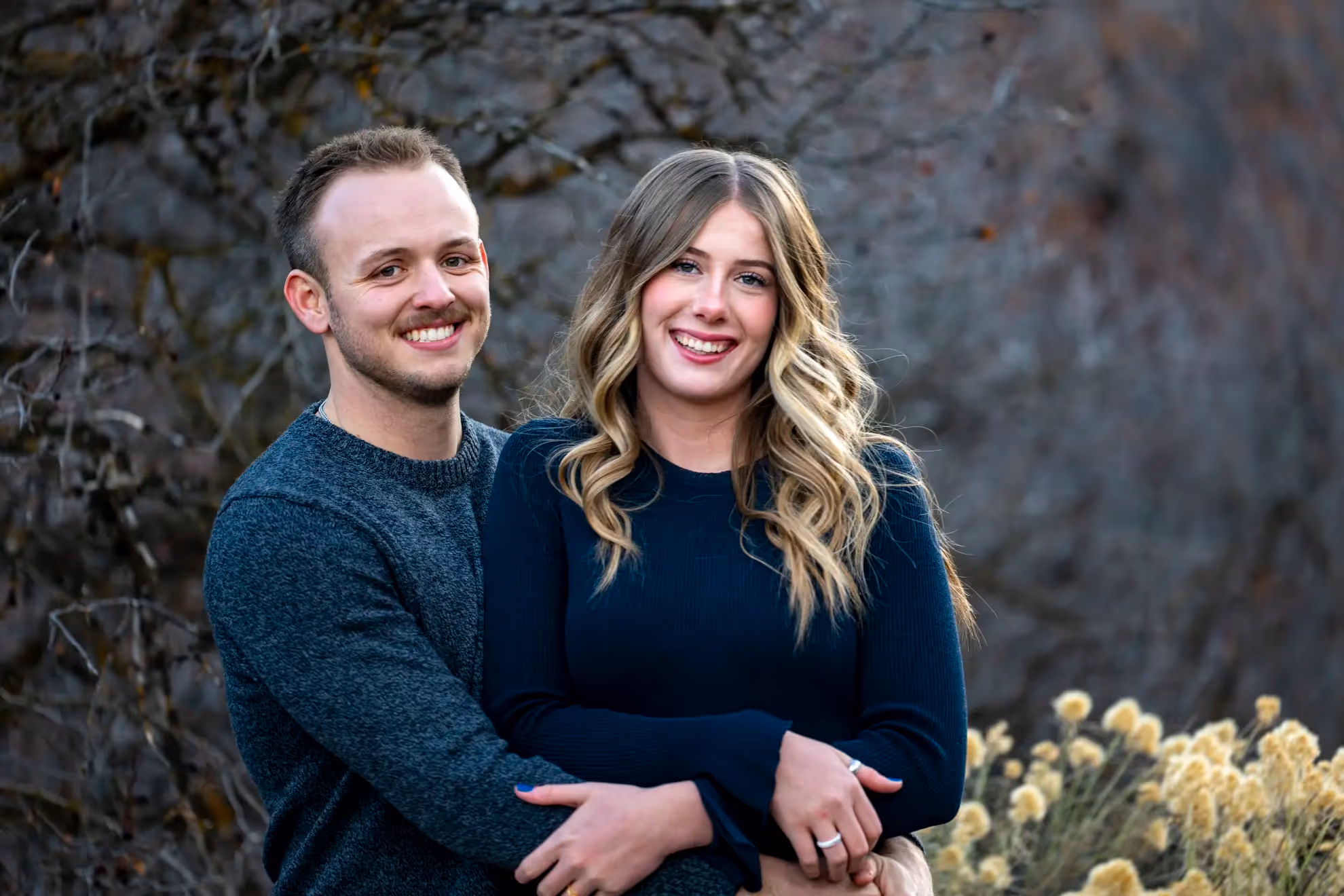 A newly engaged couple holding eachother.