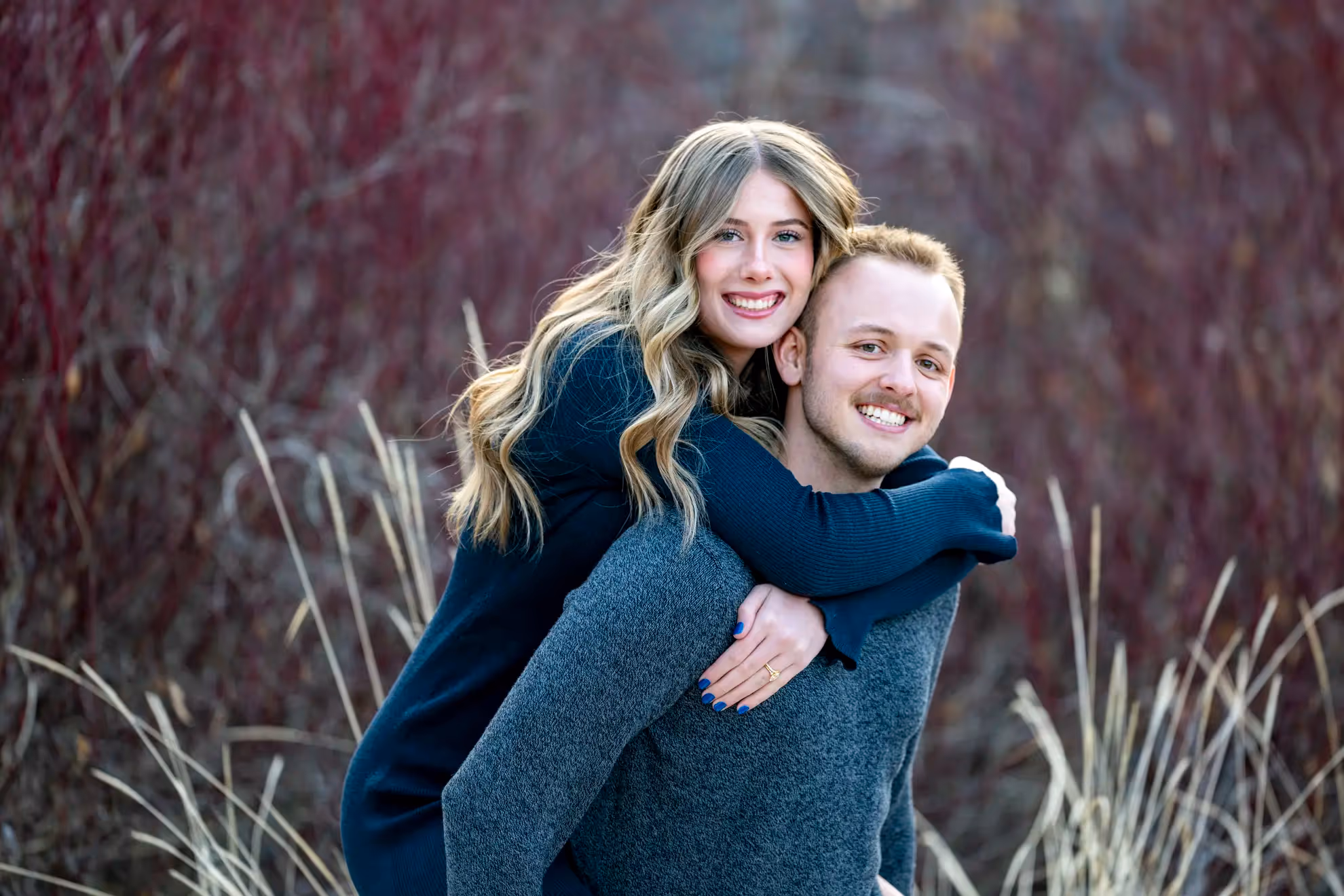 A woman getting carried by her fiance.