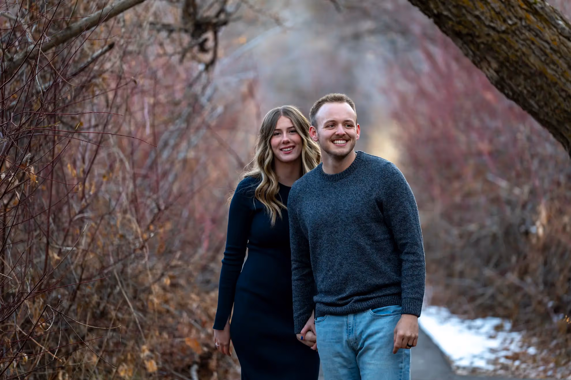 A couple walking through the woods