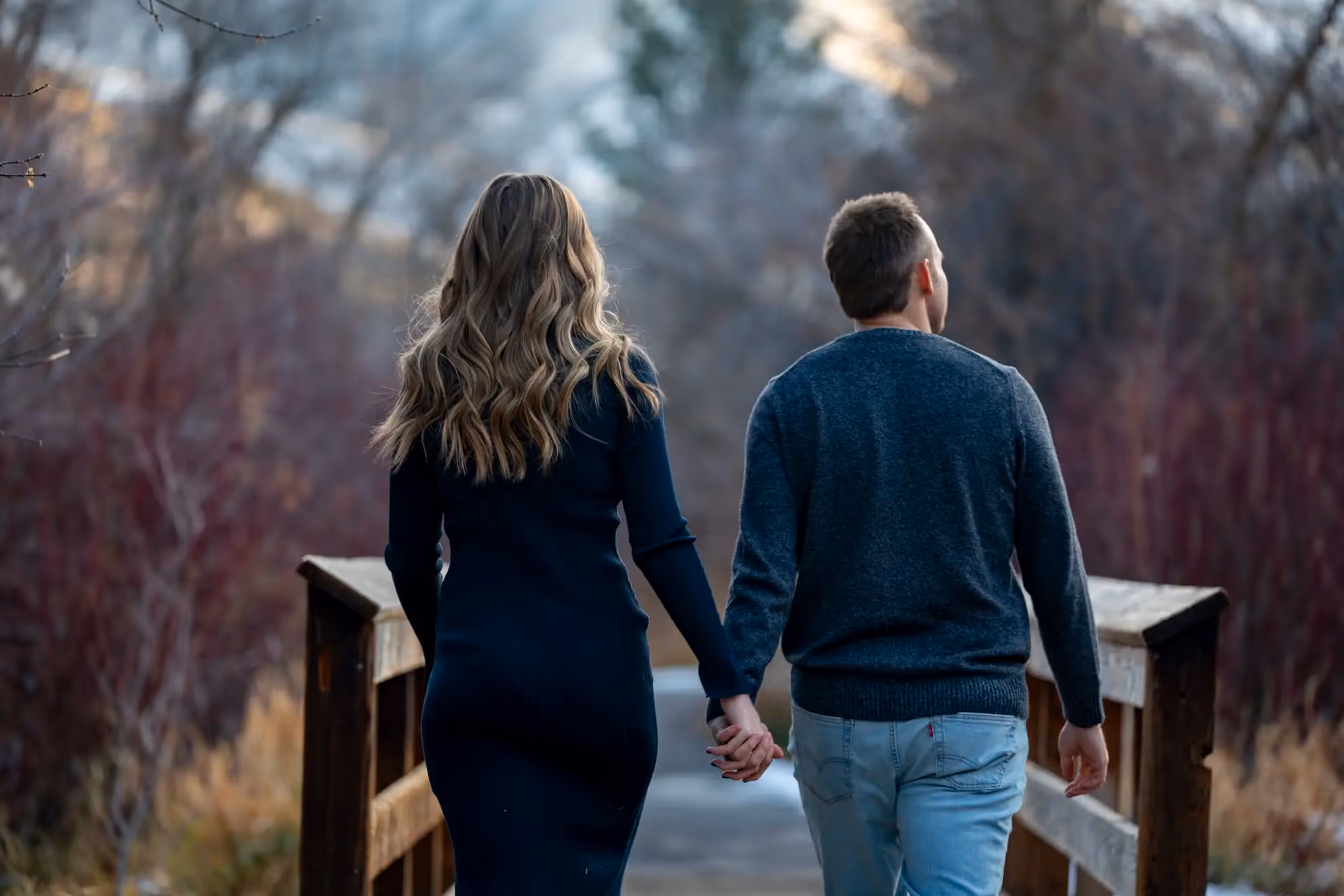 A couple walking through a bridge.