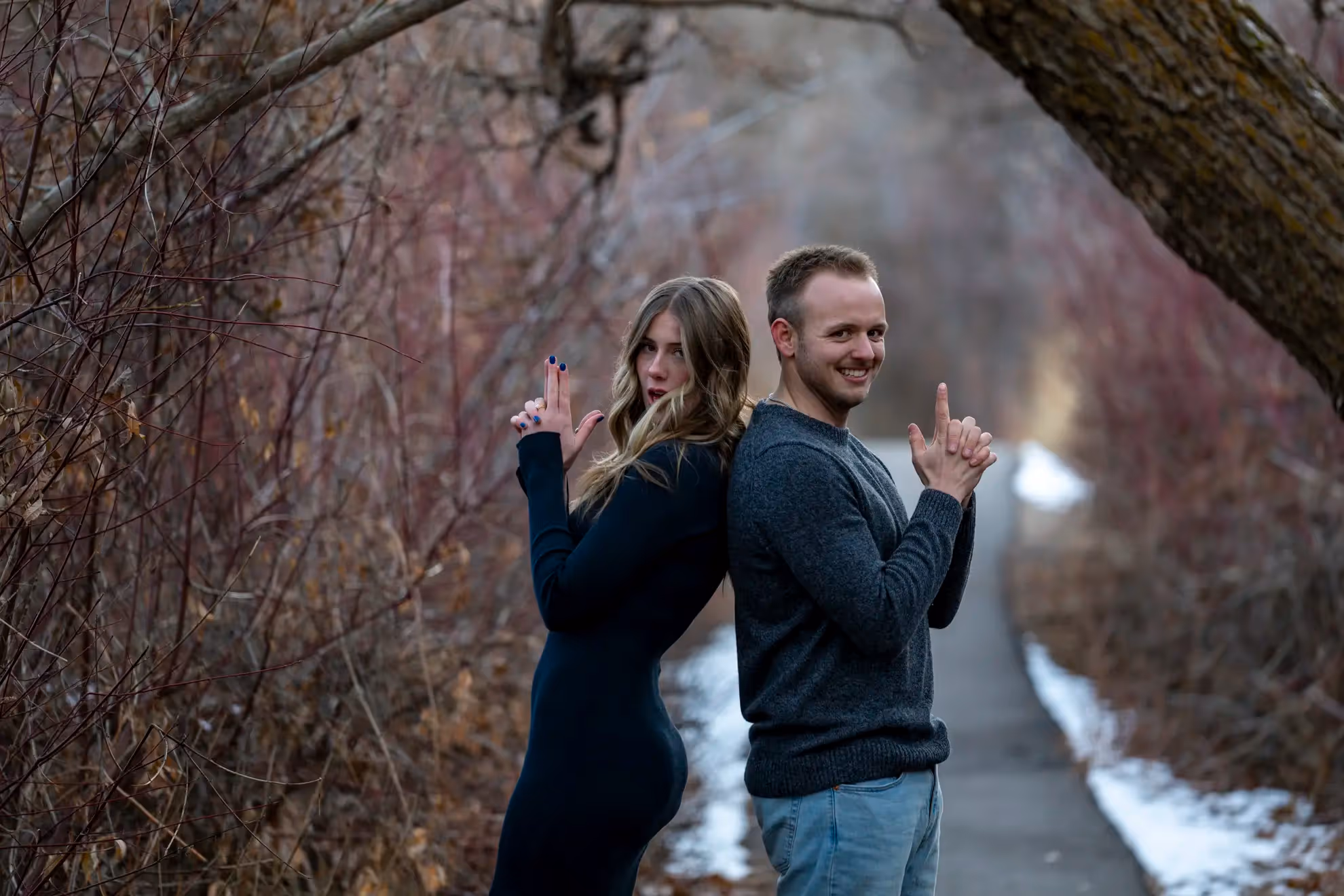 A couple doing finger guns and posing.