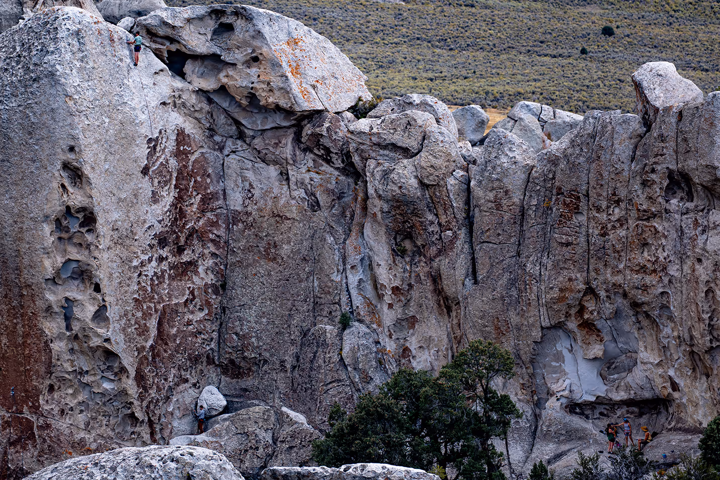 A rock climber climbing to a peak at the City of Rocks