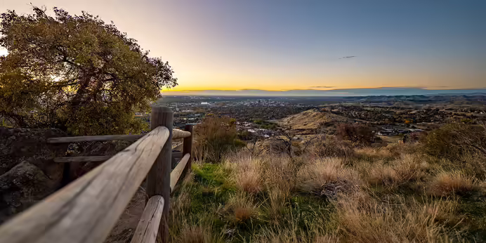 Wooden fence at Table Rock in Boise, Idaho during a colorful sunset