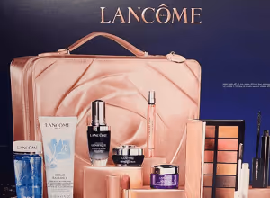 Lancome cosmetics and skincare product set with rose gold packaging.