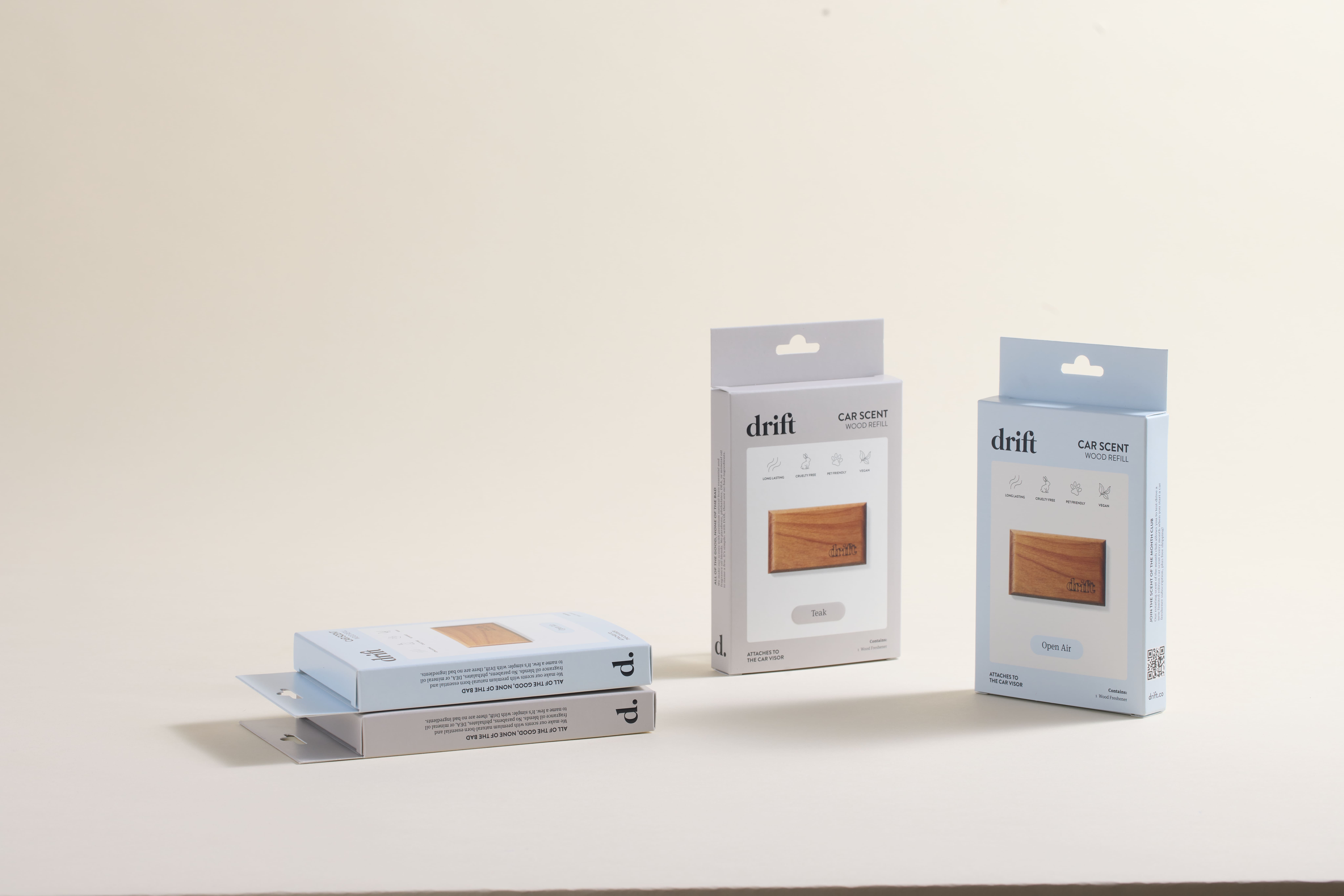 Drift car scent wood refill folding cartons in pale blue and gray with hang-tab tops and product windows, displayed upright and stacked against a neutral background—an example of retail folding carton quality assurance.