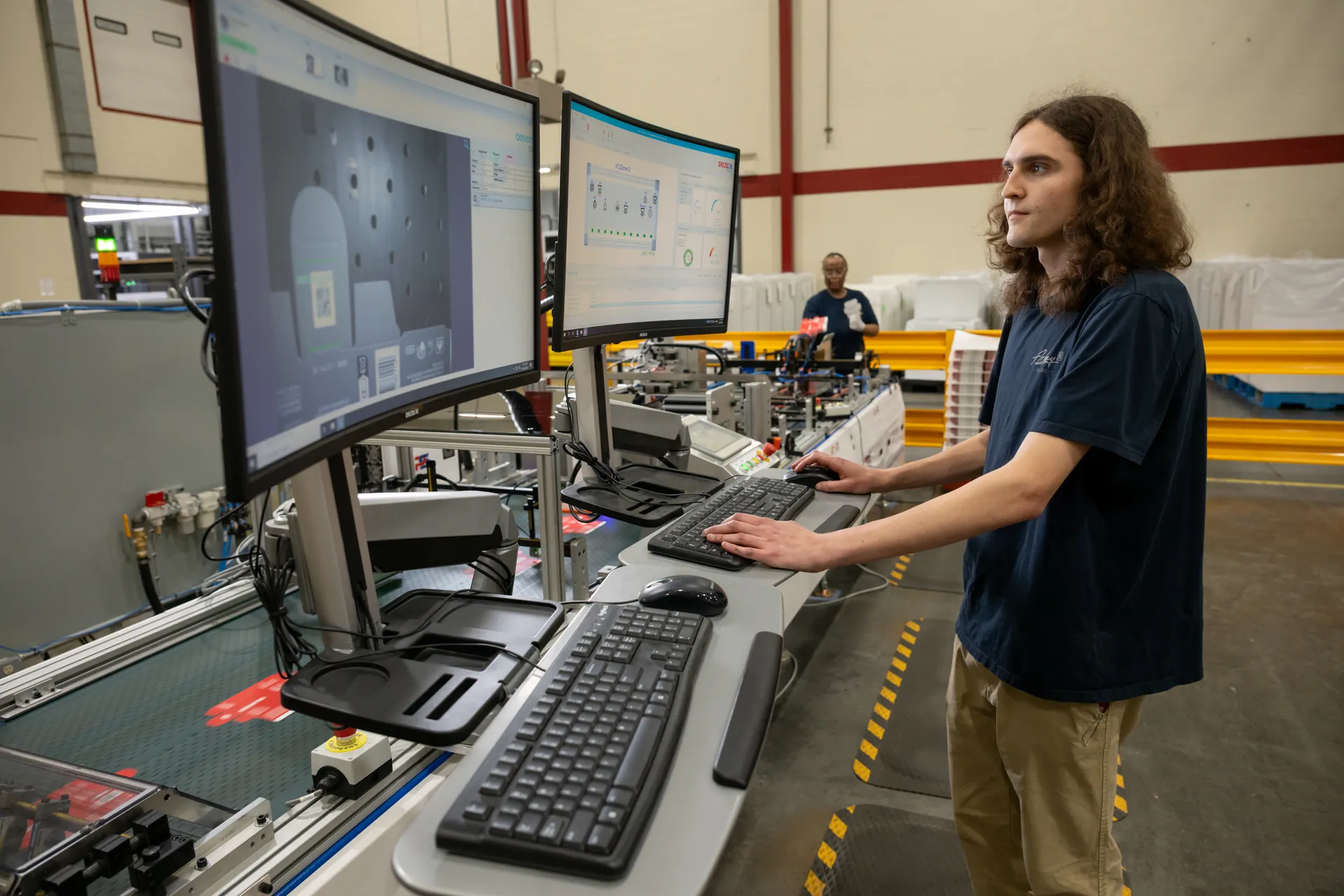 Technician using a vision-inspection system to scan QR codes on packaging for anti-counterfeiting verification