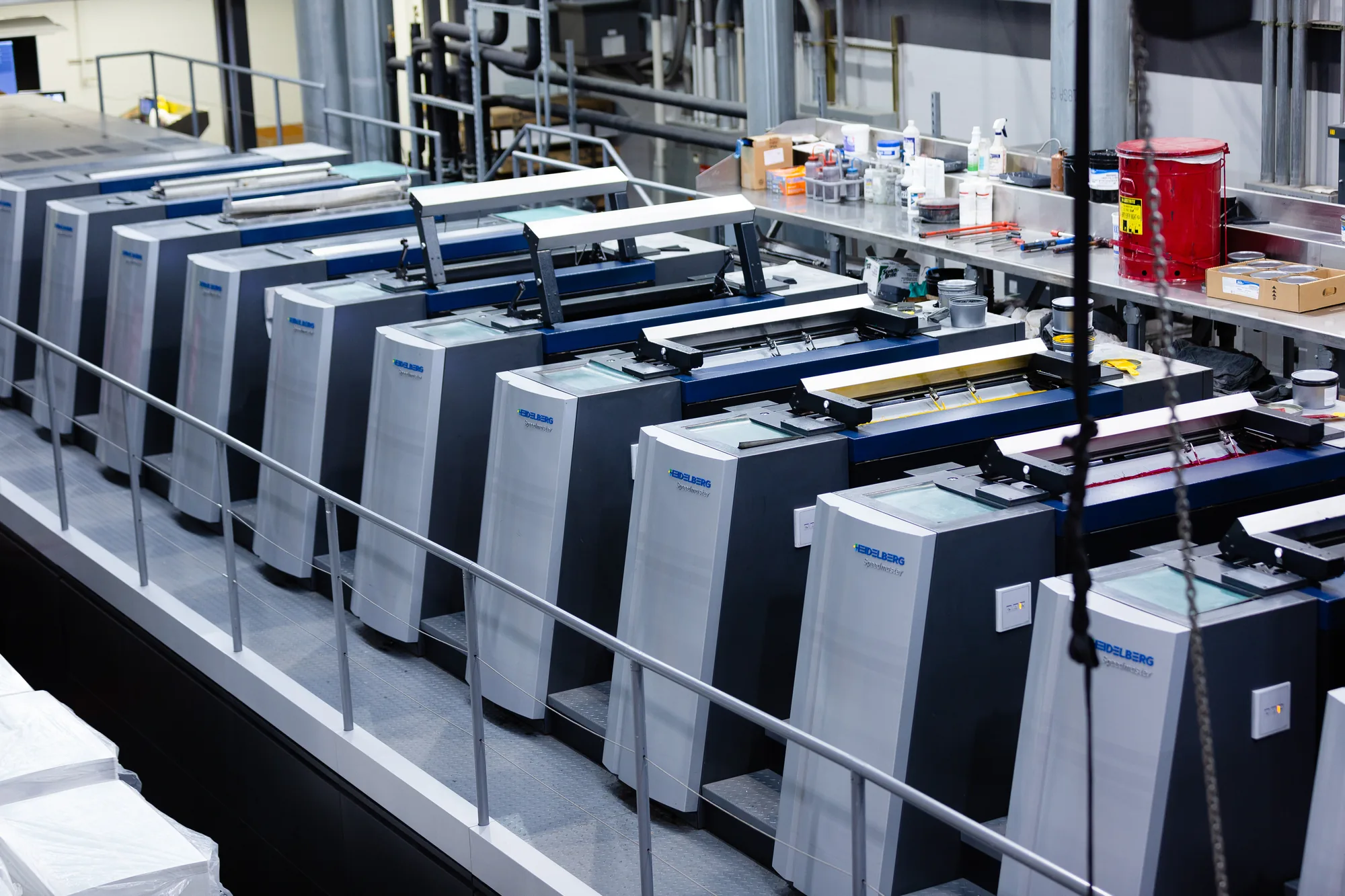 Offset press printing units in a row with open ink decks at a folding carton plant