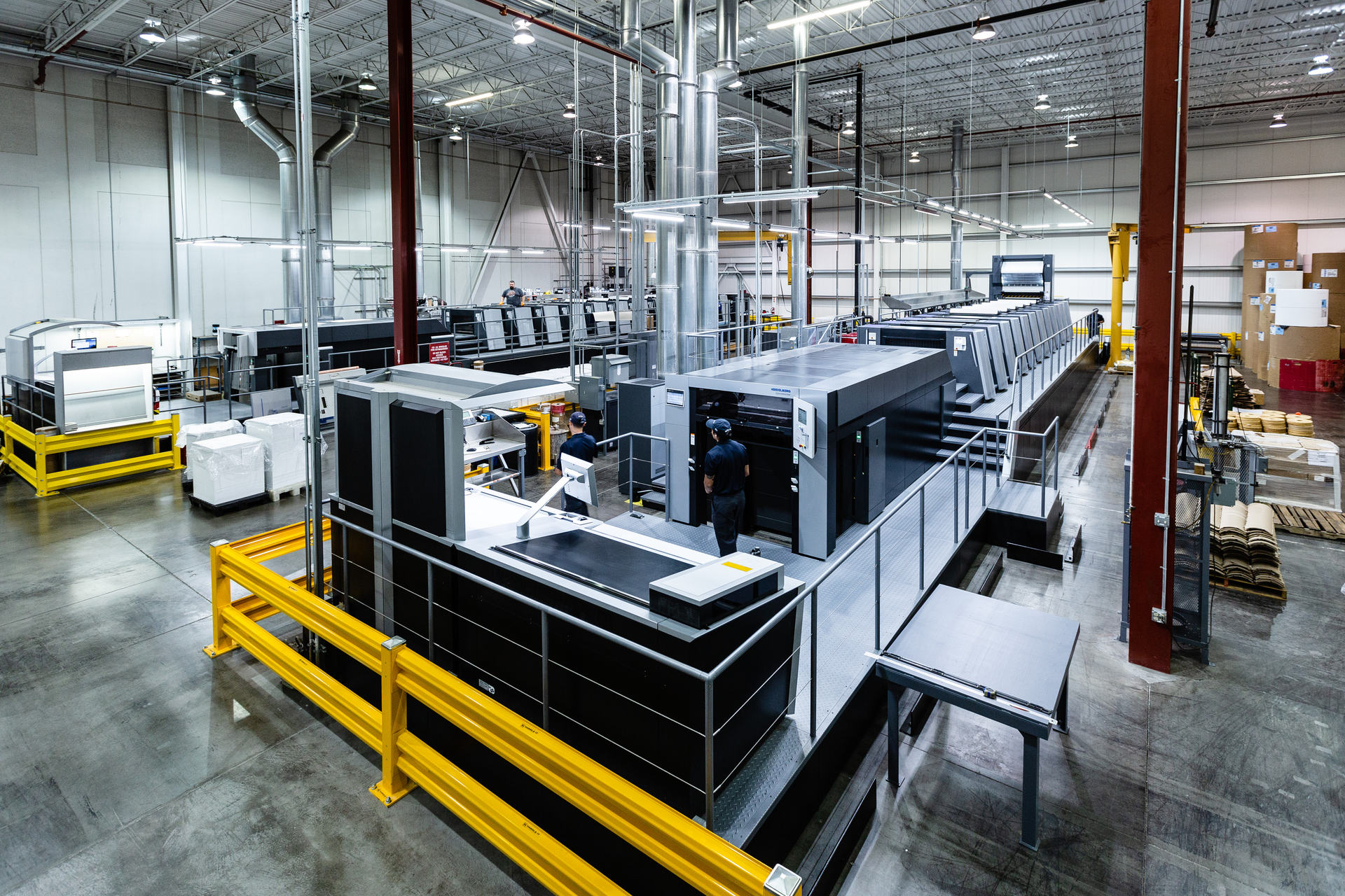 The press hall at Arkay’s Roanoke plant, with operators at a multi-unit sheet-fed offset press