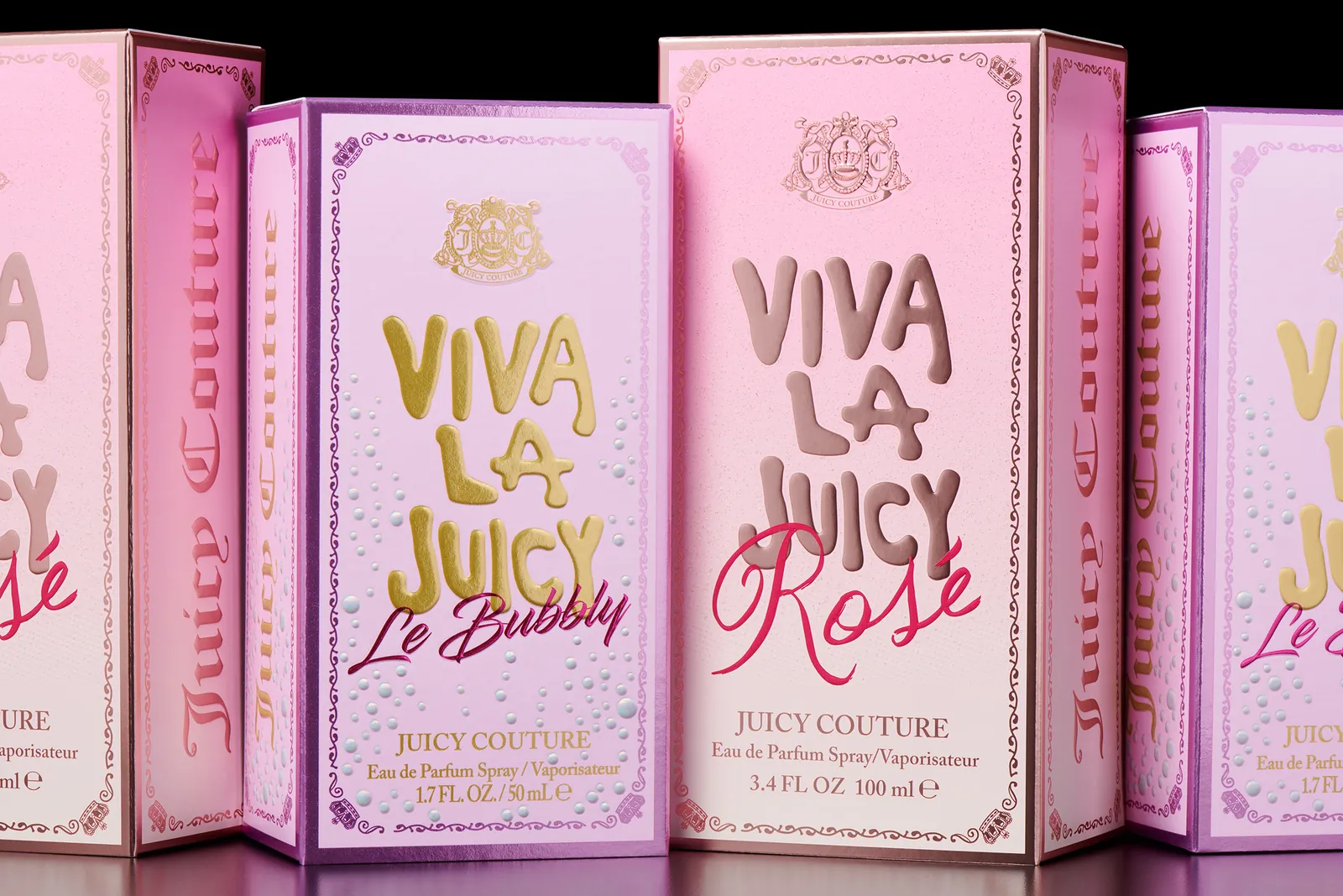 Close-up of Juicy Couture Viva La Juicy Le Bubbly and Rosé perfume cartons showing raised embossed lettering and gold foil detail