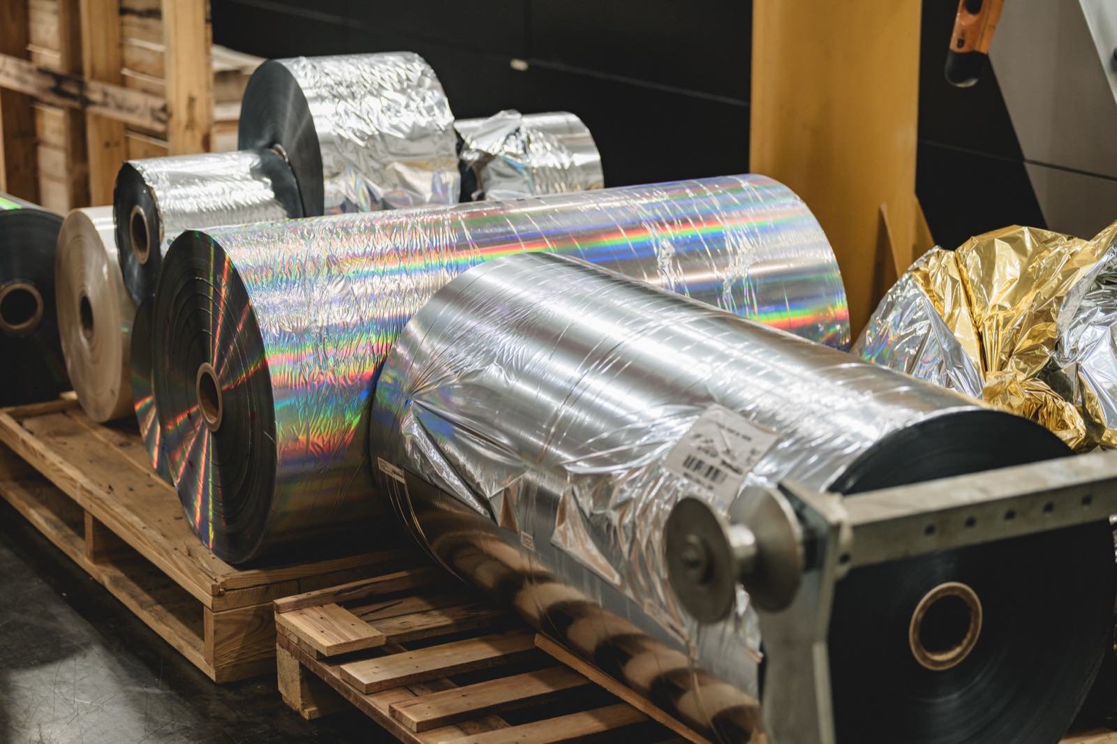 Rolls of cold foil in silver, holographic and gold on a pallet at Arkay's Roanoke facility.