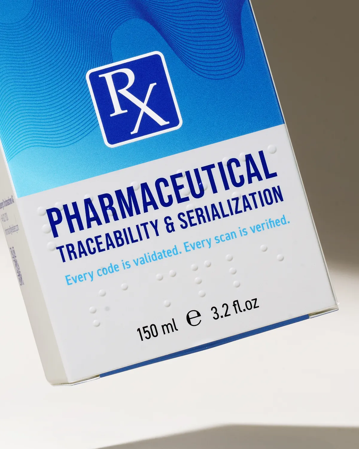 Pharmaceutical folding carton with an Rx logo and raised braille dots embossed on the white front panel