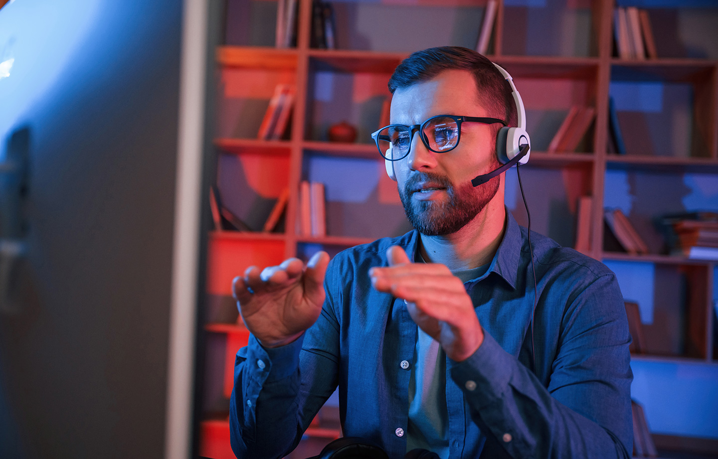 Service representative wearing headset at a computer workstation
