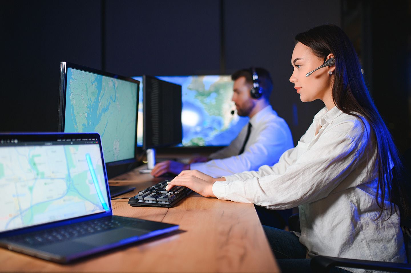 IT support technicians using enterprise remote support software across multiple monitors in a distributed operations center
