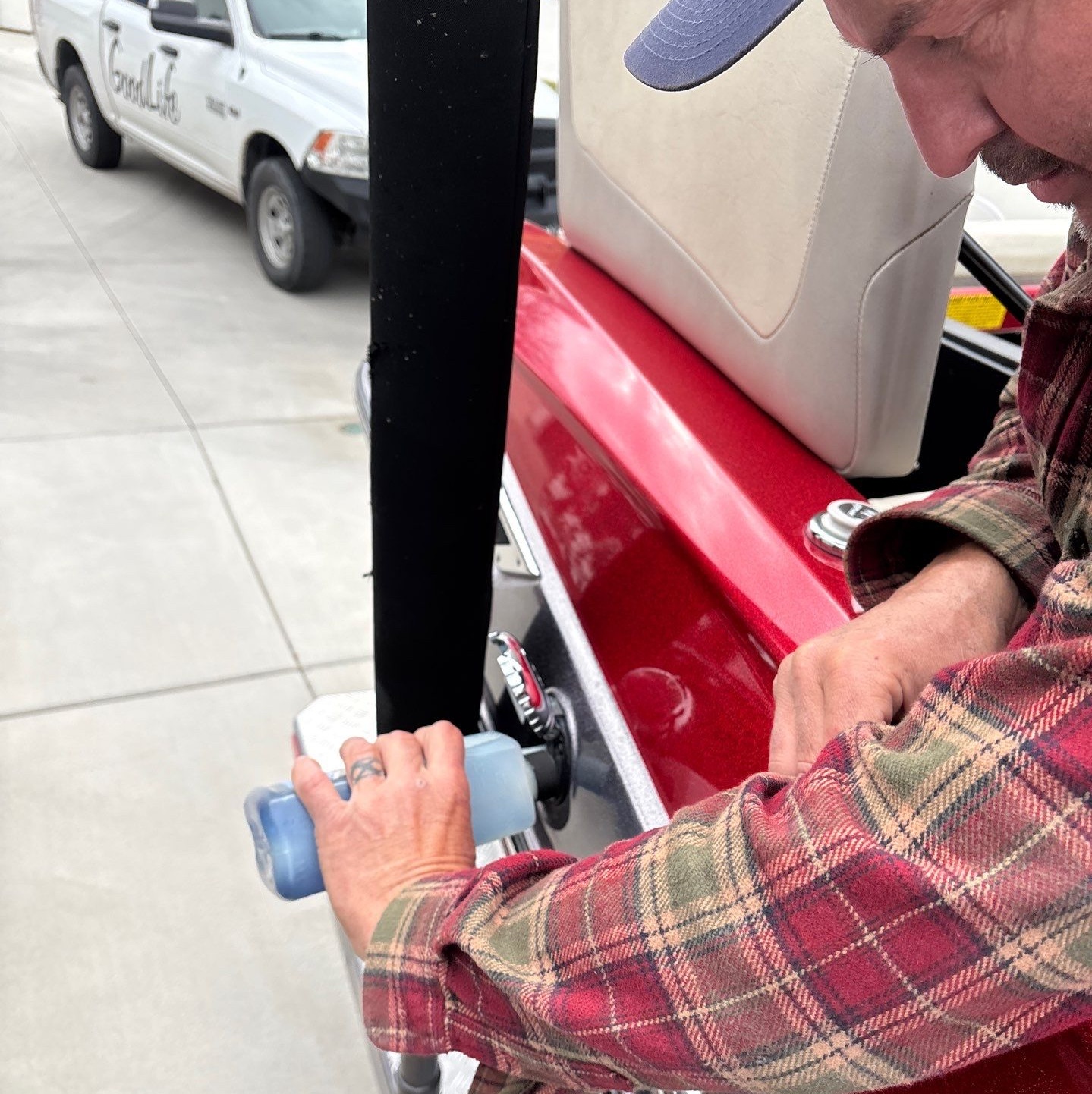 Boat technician adding fuel stabilizer as part of winterization in Sandy Utah