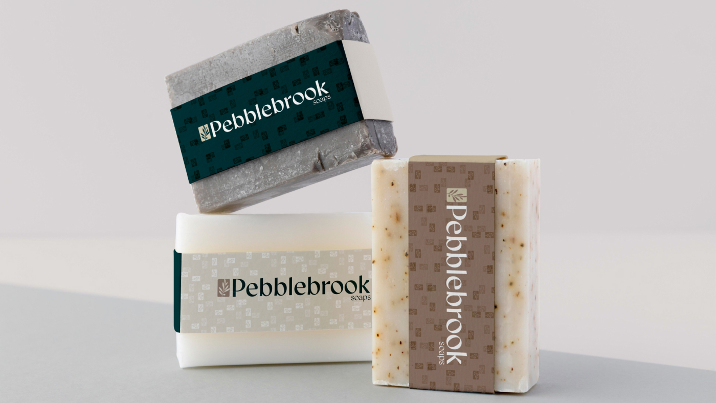Pebblebrook soaps stacked on top of each other with distinct packaging designs.