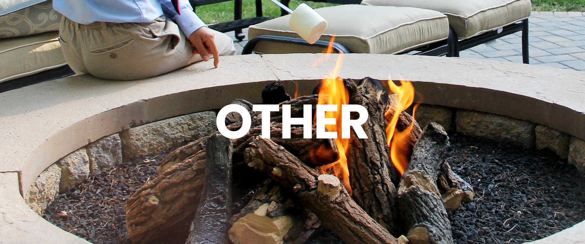 outdoor fireplace with woman roasting a marshmallow over the fire.