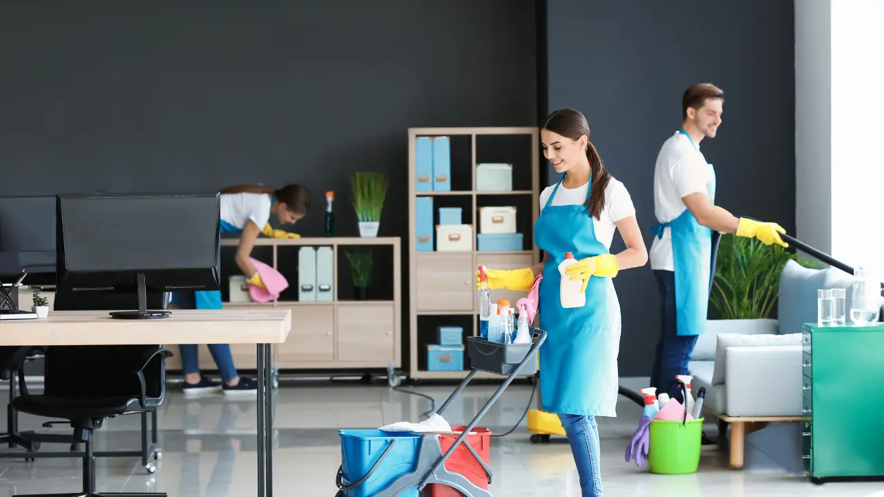 Cleaning team organizing supplies in a modern living room, representing flexible custom cleaning plans tailored to each client.