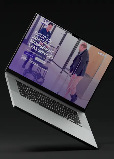 Laptop displaying a website for janitorial management and PAX services with a janitor mopping a floor.
