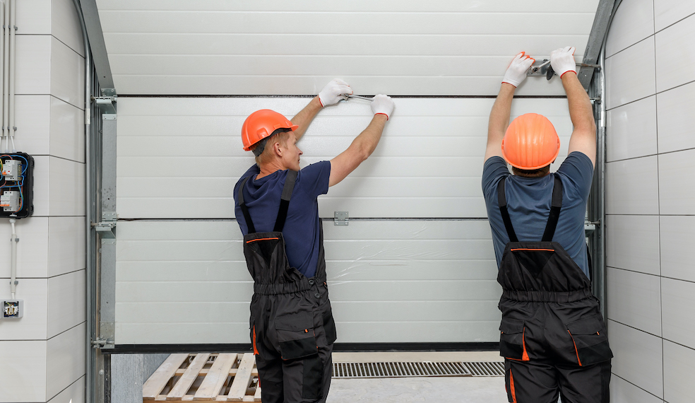 two men installing a garage door