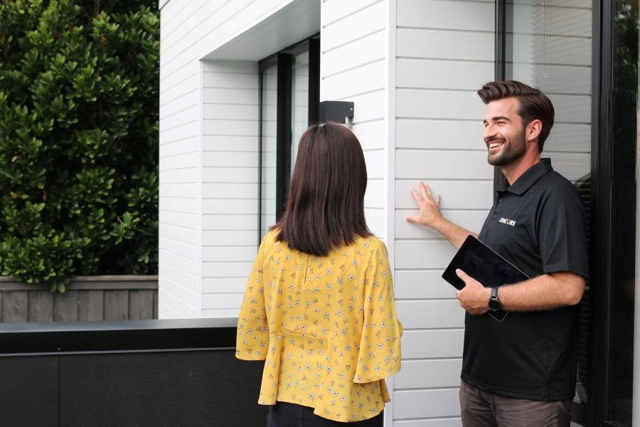 Modern New Zealand home exterior with clean, well-maintained walls, tidy garden, and bright natural lighting, representing reliable property maintenance.