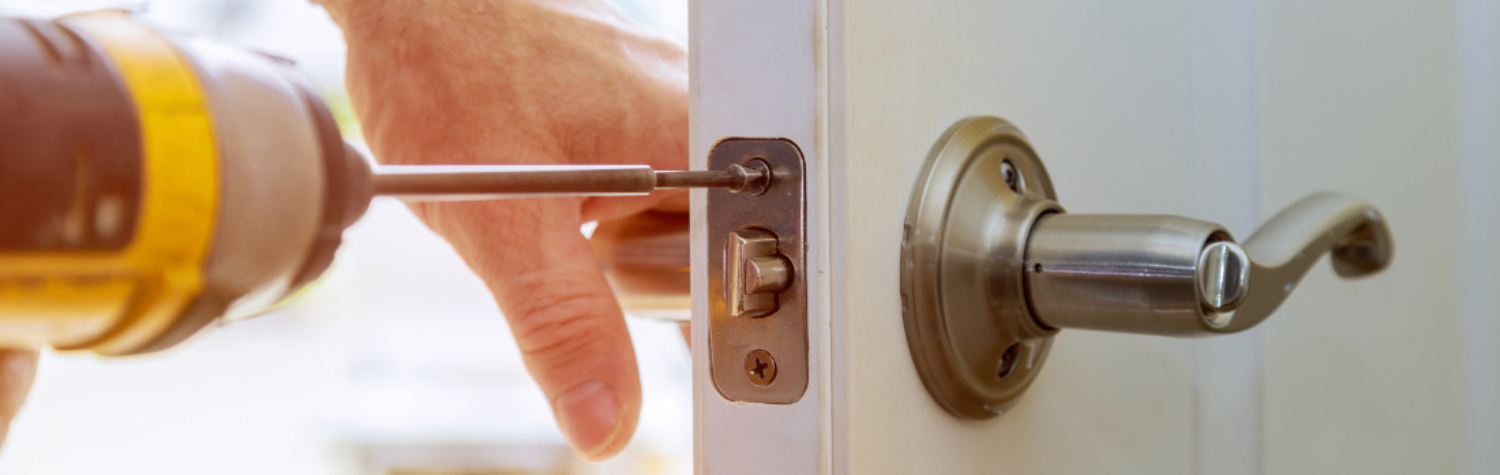 close up of handyman repairing door handle