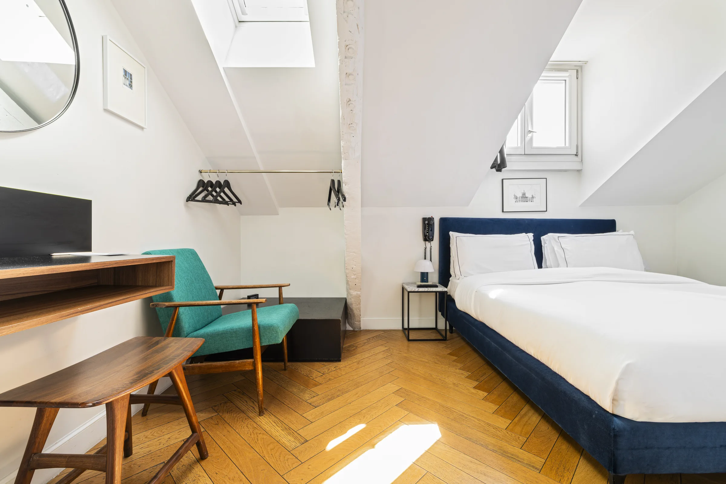Attic loft room with skylight and turquoise armchair Paris