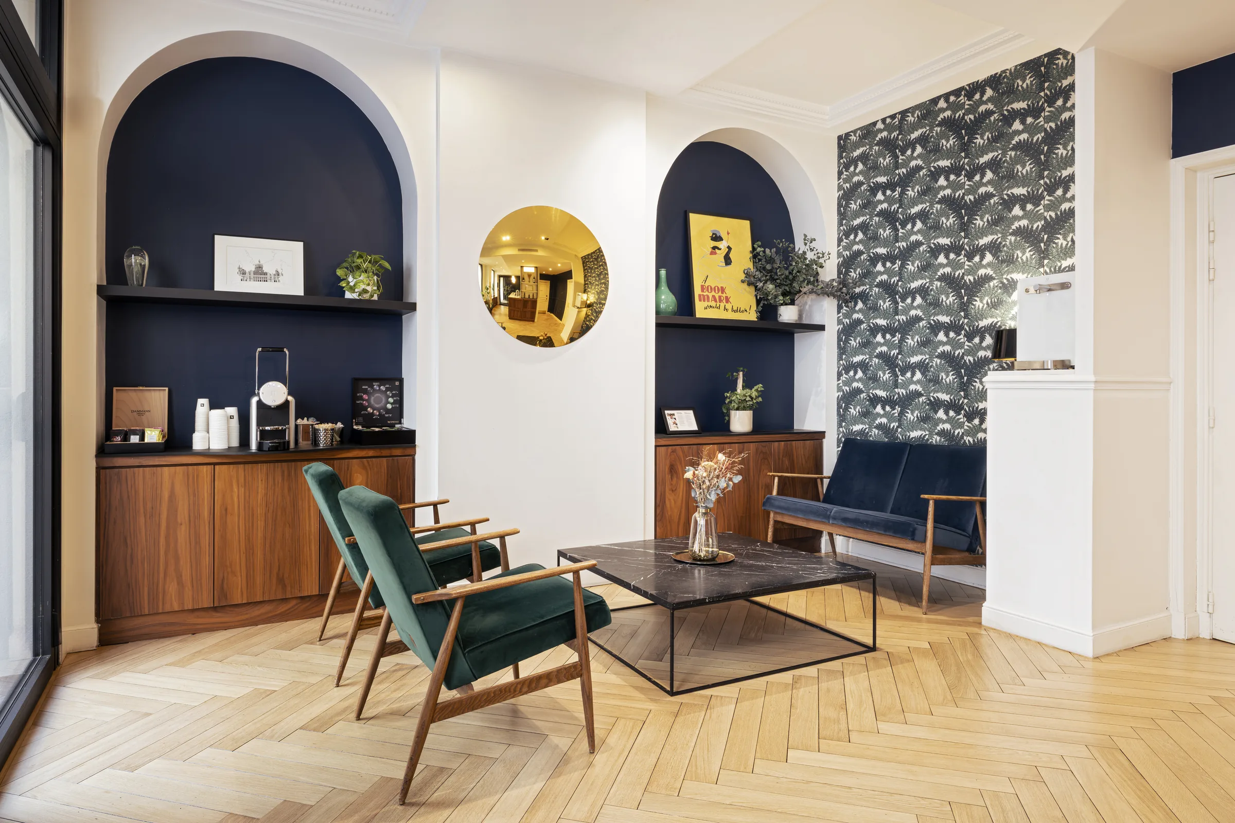 Parisian lounge with green velvet armchairs and arched niches