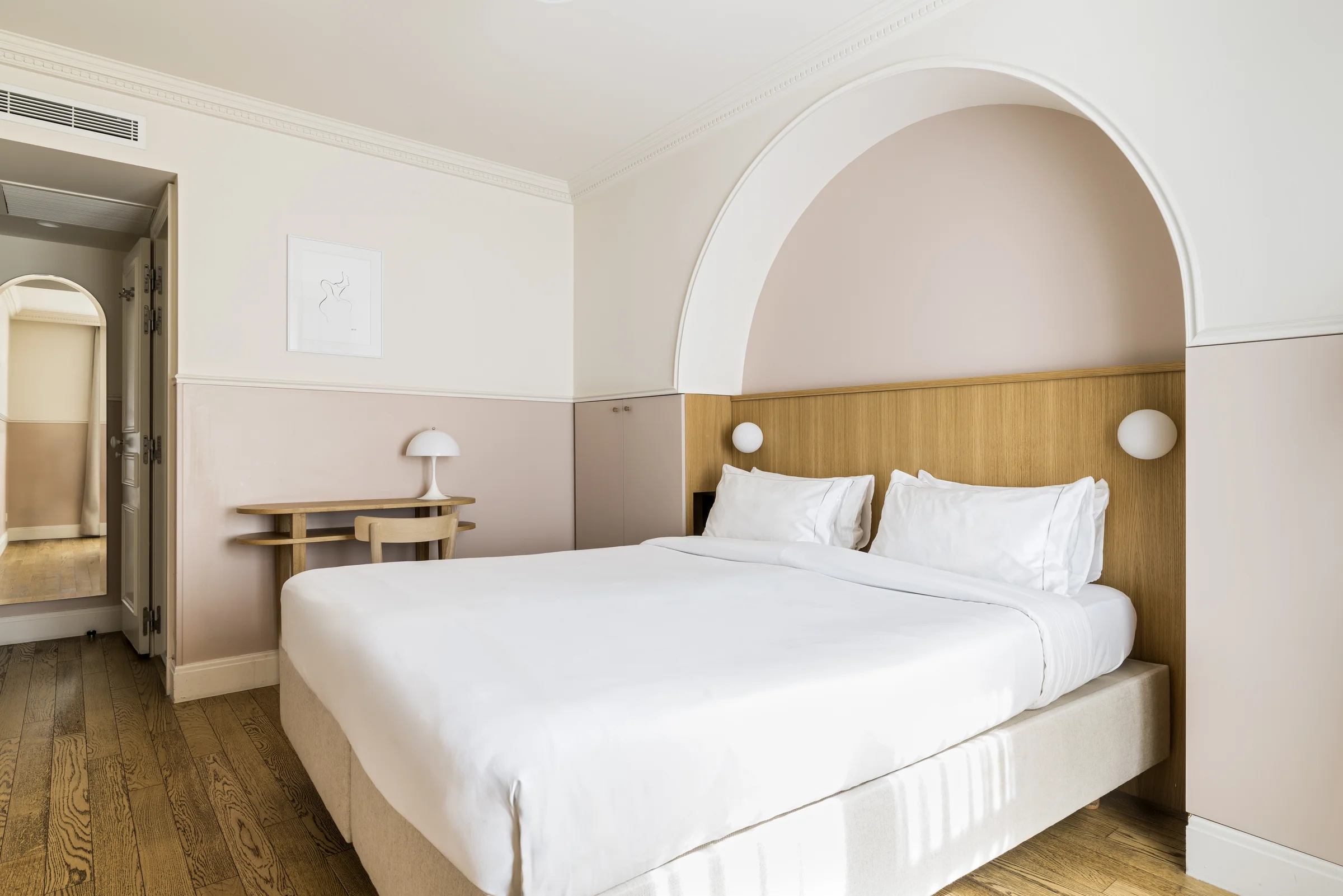Hotel Oratio Superior room with arched headboard nook, vintage oak desk and warm blush tones