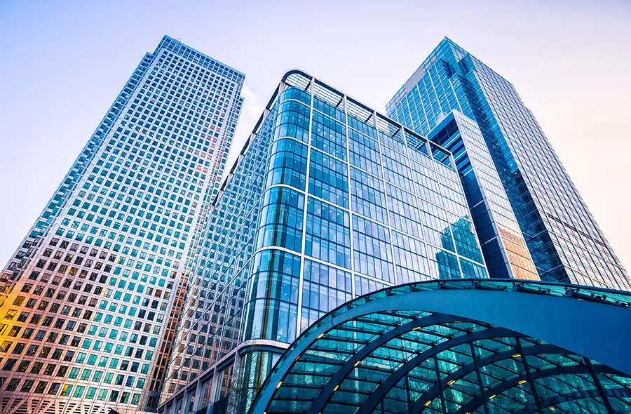 Low-angle view of modern glass skyscrapers with reflective facades in an urban business district