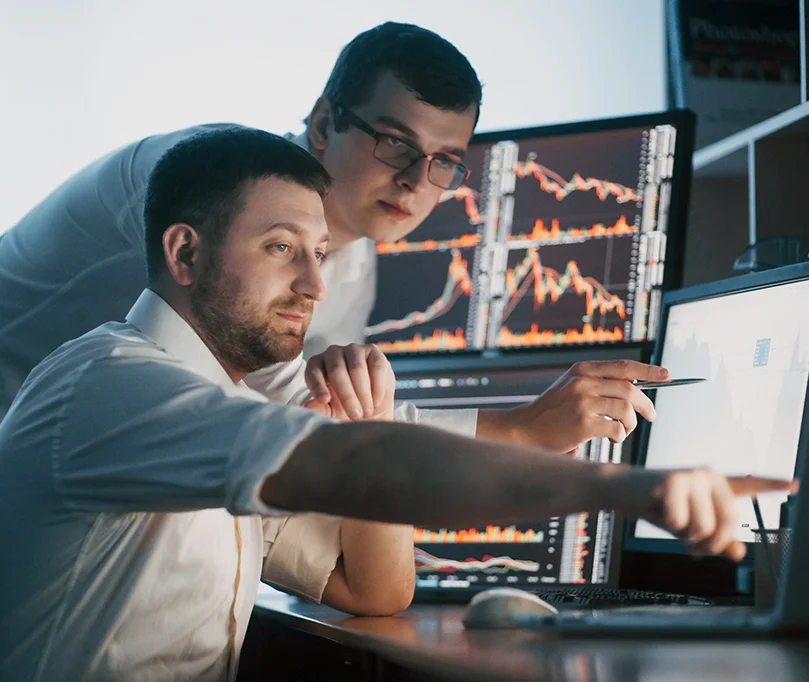 Merifund analysts reviewing market data on multi-screen workstation