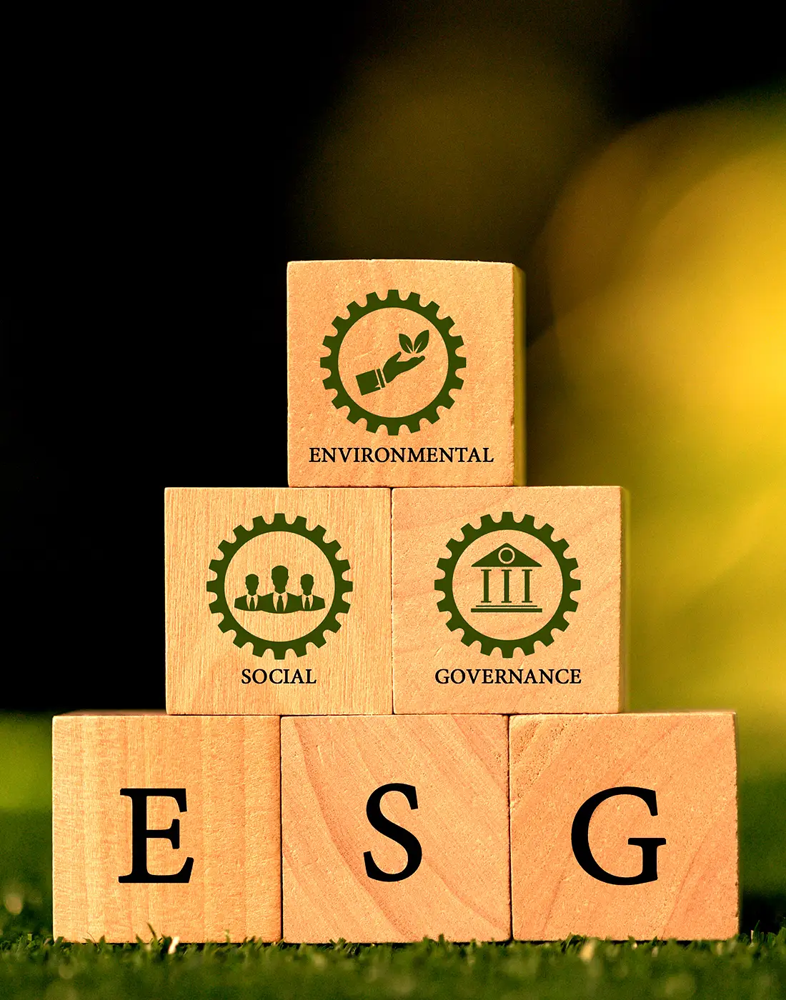 Wooden building blocks illustrating Environmental, Social, and Governance (ESG) principles, symbolising sustainable investment strategies.