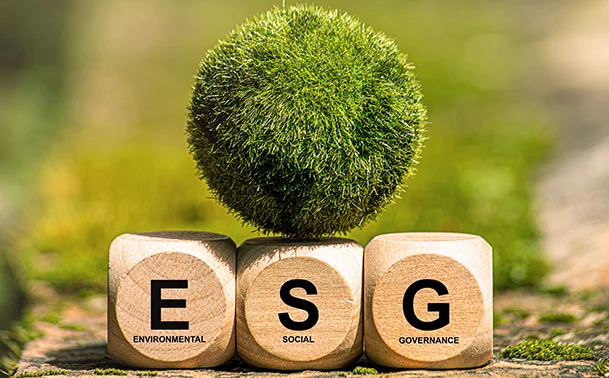 Wooden ESG blocks with a green globe, symbolising sustainable investing strategies, regulatory shifts, and long-term financial resilience in 2025.