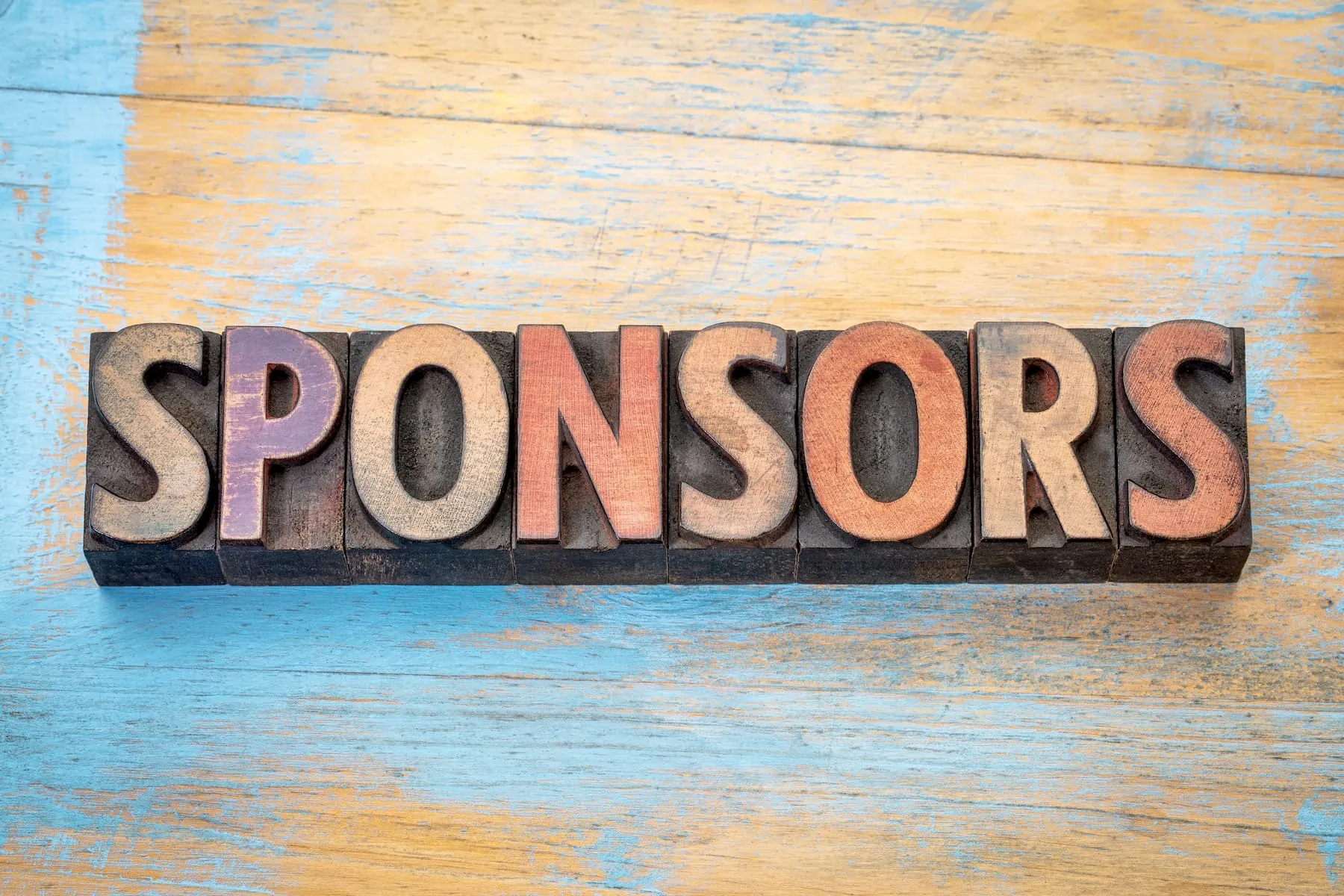 Signboard with sponsors written on it